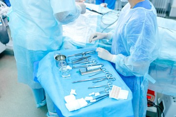 Orderlies prepare medical instruments in the operating room