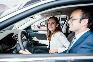 Family of businessmen sitting in the cabin of a black car