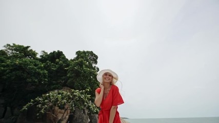 Happy blond woman in a red dress and sunhat - slow motion. - Powered by Adobe