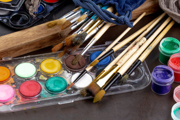 Paint brushes and paints for drawing.