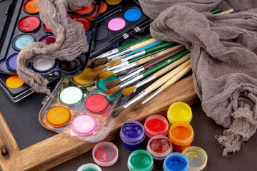 Paint brushes and paints for drawing.