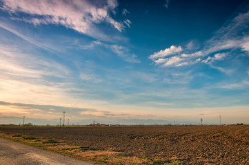 sunset with alps on the horizon in the Piedmontese countryside