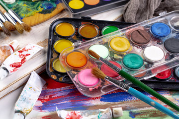 Paint brushes and paints for drawing.