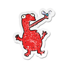 retro distressed sticker of a cartoon poisonous frog catching fly
