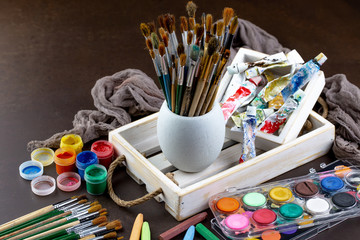 Paint brushes and paints for drawing.