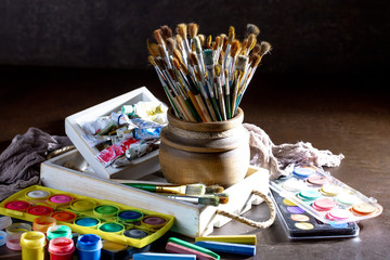 Paint brushes and paints for drawing.
