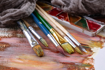 Paint brushes and paints for drawing.