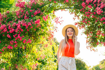 girl with long hair smiles and on her head boater. beautiful arc