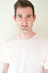 Fototapeta premium Headshot for a model. Caucasian man with brown hair mouth slightly open, looking at camera. Fit and active man who exercises and eats right on white background.