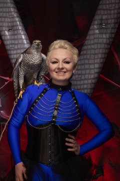 beautiful scary woman with the big hawk best friend on the background of dark room