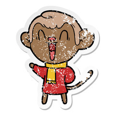 distressed sticker of a cartoon laughing monkey