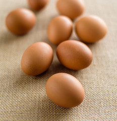  Fresh eggs in wicker basket  on wood table Prepare chicken eggs and egg whisk for cooking or bakery can use for background or wallpaper.