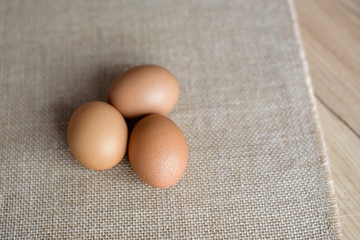  Fresh eggs in wicker basket  on wood table Prepare chicken eggs and egg whisk for cooking or bakery can use for background or wallpaper.