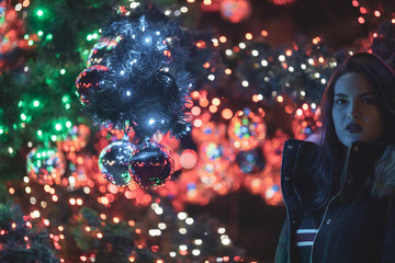 woman in black dress on street of city at night