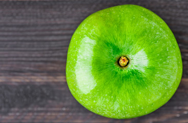 One green apple. Place for text. Top view