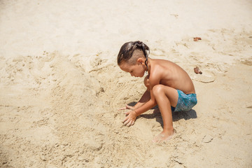 little boy built a sand castle 