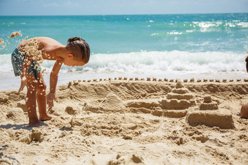 little boy built a sand castle 