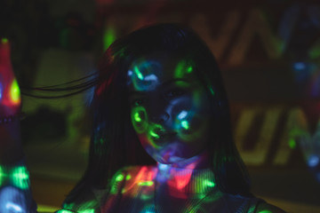 woman in black dress on street of city at night