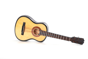 Obraz na płótnie Canvas Wooden acoustic guitar - miniature. Realistic guitar toy