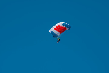 Colorful parachute in blue sky