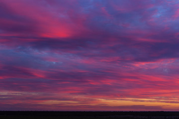 Landscape with bloody sunset. The terrain in southern Europe. Tragic gloomy sky. Purple-magenta clouds.