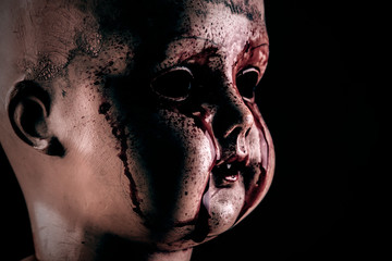 Creepy bloody doll in the dark
