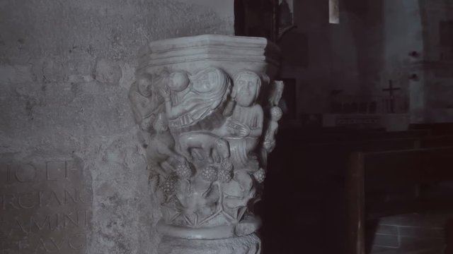 Ancient vase with the image of ancient characters in a darkened church room attracts the attention of tourists. Shot in motion