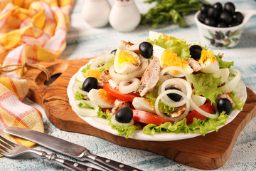 Healthy salad of organic lettuce with chicken, tomatoes, eggs, black olives and white onions