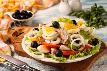 Healthy salad of organic lettuce with chicken, tomatoes, eggs, black olives and white onions