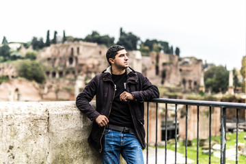 Fototapeta na wymiar Young handsome man looking at Roman forum