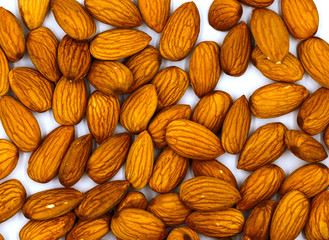 Almond nuts on white background with place for text. Almond nut flat lay. Almond heap top view.