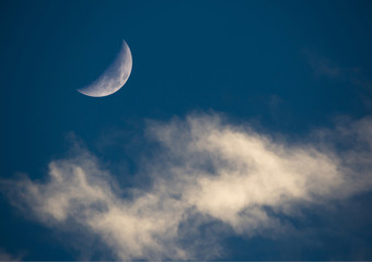Obraz na płótnie Canvas Crescent Moon and Wispy Clouds in Dark Blue Sky