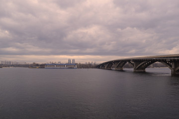 View of the river and bridge away in cloudy weather in nature.