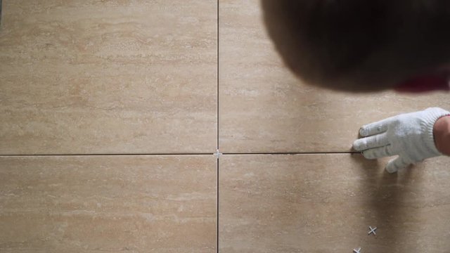 Installing ceramic floor tiles - measuring and cutting the pieces. Construction, renovation, repair apartment