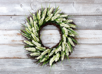 Natural flower wreath on white weathered wooden background