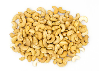 Cashew nuts on white background, top view photo. Tasty healthy snack. Scattered nut on table. Organic food