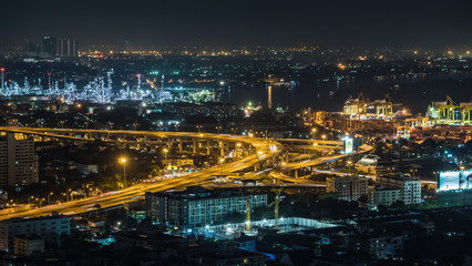 Fototapeta na wymiar Bangkok city, Thailand, showing traffic on motor way, oil refinery and shipping port at night