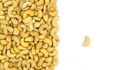 Cashew nuts on white background, top view concept photo. Scattered nut on table. Organic food rustic banner template