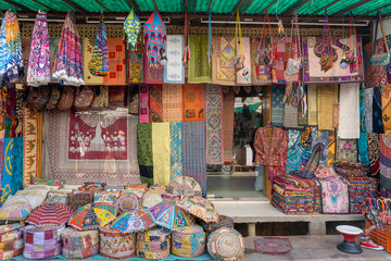 Assortment of colorful fabrics and souvenirs for sale in local market in Pushkar, Rajasthan, India