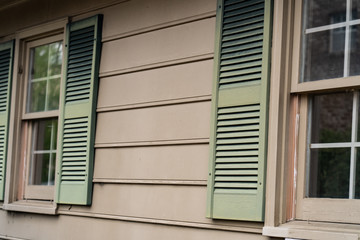 Faded shutters on the outside of a building