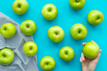 green apples for organic summer food pattern on blue background top view