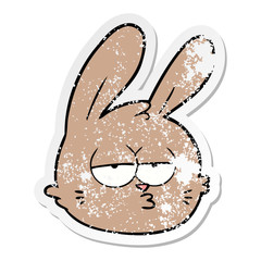 distressed sticker of a cartoon jaded rabbit face