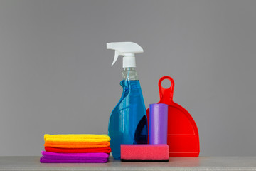 Colorful set of tools for cleaning the house on neutral . The concept of spring cleaning. Place for text.