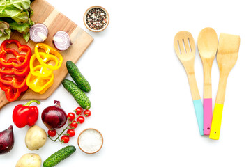 cooking with raw vegetables on white background top view