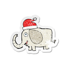 retro distressed sticker of a cartoon elephant in christmas hat