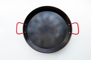 Seasoned carbon steel paella pan isolated on white background, top view