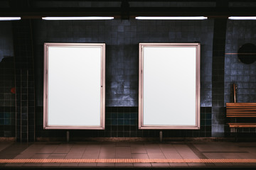 Two empty ad vertical posters templates on a metro platform; blank information banners placeholders...