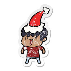 Obraz premium distressed sticker cartoon of a laughing boy wearing santa hat