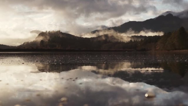 Misty mountains calm ocean