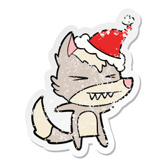 angry wolf distressed sticker cartoon of a wearing santa hat